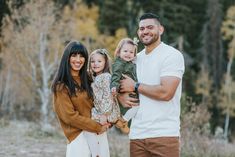 a man and woman holding two small children