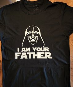 "This is a total custom-made shirt. 100% cotton, comes in a variety of sizes and colors. You can personalize it, otherwise it will include the default message \"I AM YOUR FATHER\"" Black Pre-shrunk Shirt For Fan Conventions, Cotton T-shirt With Letter Print For Fan Conventions, Cotton Fandom T-shirt For Fan Conventions, Unisex Crew Neck T-shirt For Father's Day, Father's Day Unisex Crew Neck T-shirt, Black Letter Print T-shirt For Fan Conventions, Fitted Short Sleeve T-shirt For Father's Day, Cotton T-shirt With Text Print For Fan Conventions, Black Cotton Fandom T-shirt