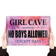 a person holding up a sign that says girl cave no boys allowed except dad