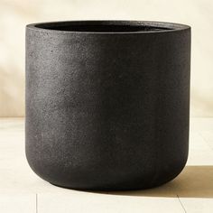 a black pot sitting on top of a white floor