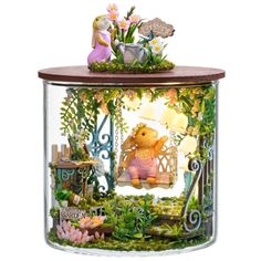 a glass jar filled with lots of plants and animals