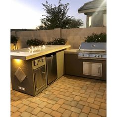 an outdoor kitchen with stainless steel appliances