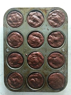 a muffin tin filled with chocolate cupcakes