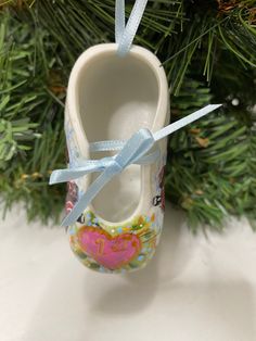 a shoe ornament hanging from a christmas tree