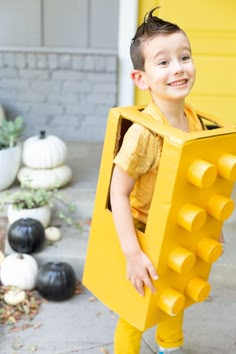 a young boy dressed up as a lego character