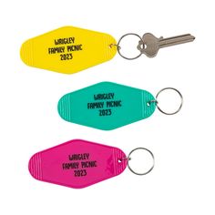 three different colored keychains with the names of family members and families on them