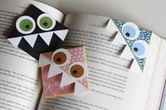 three owls made out of paper sitting on top of an open book