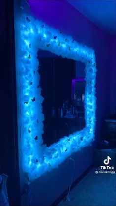 a mirror that is lit up with blue lights