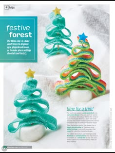 an advertisement for festive forest with two small trees made out of marshmallows