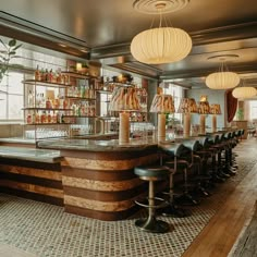 a bar with lots of bottles on the shelves and stools in front of it