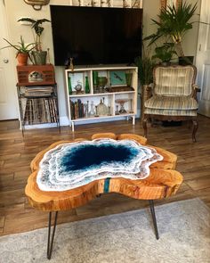 a living room with a coffee table made out of wood and blue agate paint