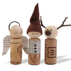 three wooden peg dolls are standing next to each other