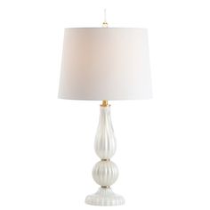 a table lamp with a white shade on the base and a gold trimming around it