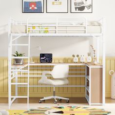 a white loft bed sitting next to a desk with a computer on top of it