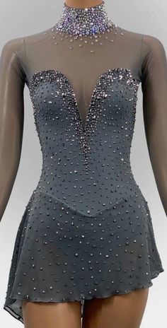 the back of a woman's body wearing a grey dress with silver sequins