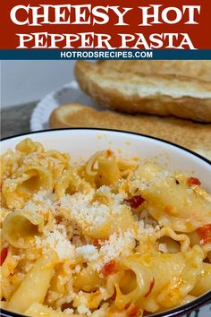 cheesy hot pepper pasta in a bowl with bread on the side