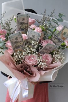 a woman holding a bouquet of flowers and money