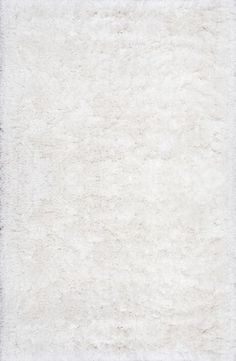 an area rug with white fur on it