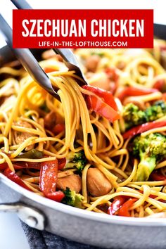 a pan filled with noodles, broccoli and red peppers being held by tongs