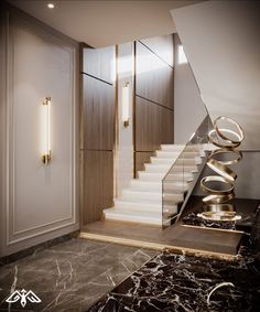 an elegant staircase with marble flooring and gold accents in a modern style home setting