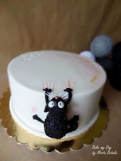 a birthday cake with an image of a black cat on it's side and the words, have the rite god birthday lovely she