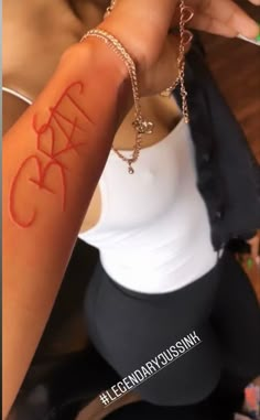 a woman is showing off her arm with the word crazy on it's side