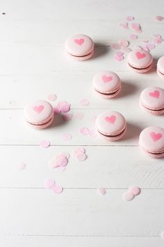 pink macaroons with hearts scattered around them