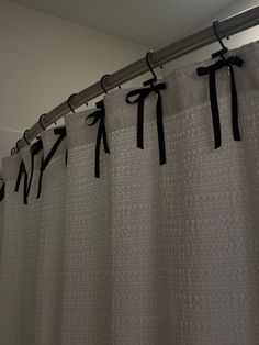 a shower curtain with black ribbon on it