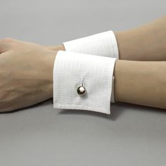 Decorative detachable shirt cuffs will help you to complete your unique look. It is possible to wear them with a jacket, uniform, dress, or sweater. Or you could wear them with a T-shirt. Be special, and create your own unique style! Please find out the length of your wrist to choose the right size. You may order exactly your size or a larger one if you want the cuff not to be tight. Before ordering, watch my video on the channel on how to measure your wrist. This is necessary so that you choose the correct cuff size. These sizes are only suitable for my store https://www.youtube.com/watch?v=ez5bpwRrkLA Cuffs is produced from 100% cotton. Sizes: Width: 7 cm / 2.8 inches The size is based on your wrist circumference. The size is the length of the cuffs band. Please measure your wrist. Pleas Shirt Cuff Pattern, Adjustable Open Cuff Bracelet For Formal Occasions, Classic Open Cuff Bracelet For Formal Occasions, Elegant Formal Cuff Bracelet, Elegant White Cuff Bracelet, Formal White Cuff Bracelet, White Formal Cuff Bracelet, Adjustable Cuff Bracelet For Formal Occasions, Cuffs On Sleeves