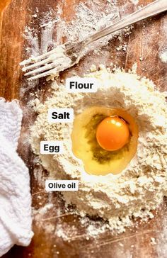 flour, salt, egg and olive oil on a wooden table