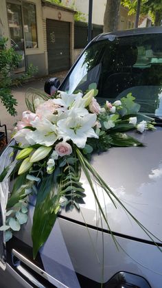 a bouquet of flowers is placed on the hood of a car