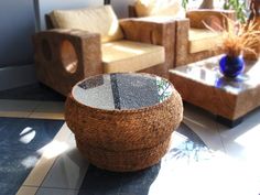 a living room filled with lots of furniture next to a plant on top of a table