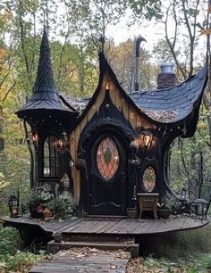 a black and brown fairy house in the woods