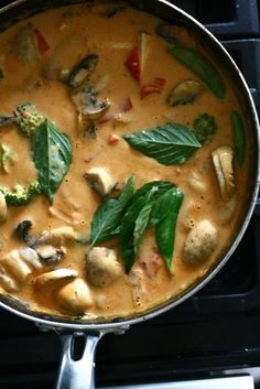 a pan filled with food sitting on top of a stove