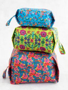 three colorful bags stacked on top of each other