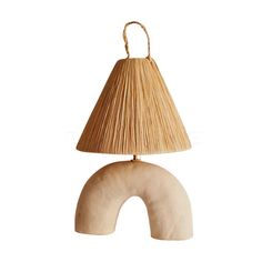 a lamp that is sitting on top of a wooden base with a light shade over it