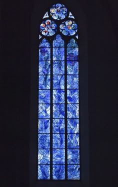 a stained glass window in a dark room