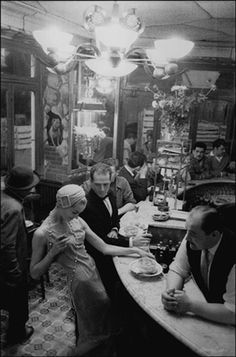 a group of people sitting around a table in a restaurant