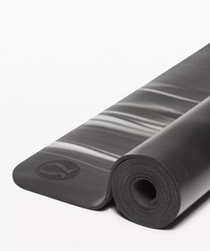 a black yoga mat rolled up on top of each other