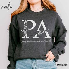 Welcome to NeelieBoutique!  This charming physician assistant sweatshirt has a whimsical botanical letter design. This cozy and stylish sweatshirt is perfect for physician assistants who want to show a little personality while staying warm and comfortable.   Also makes a terrific gift for someone graduating from PA school or a current PA student. Whether you're working hard in the hospital or spending time with friends and family, this sweatshirt will keep you warm, comfortable, and stylish.   DETAILS This classic, unisex, heavy-blend crewneck sweatshirt is super comfortable! Made from 50% cotton, 50% polyester, this combination will fit like a well-loved favorite. The collar is ribbed knit, so it retains its shape even after washing, and there are no itchy side seams. As with any online p Gifts For Physician Assistant Students, Pa School Acceptance, Future Physician Assistant, Pre Physician Assistant, Dermatology Physician Assistant, Nurse Practitioner Sweatshirt, Botanical Letters, Pa Student, Pa School