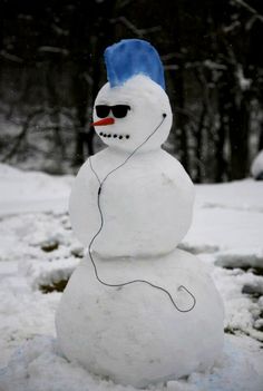 a snowman with sunglasses on it's head and earphones attached to its nose