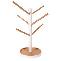 a white and wood stand with four wooden sticks on it's sides, in front of a white background