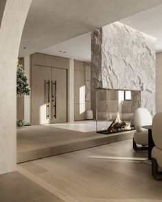 a living room with a fire place in the middle and stone walls on both sides