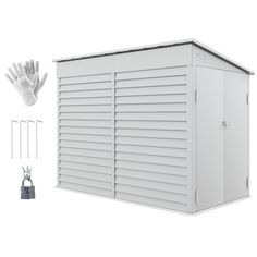 a white storage shed with the door open and gloves next to it