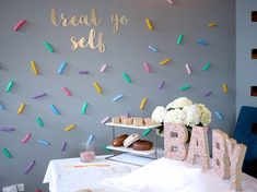 a baby shower party with confetti and sprinkles on the wall