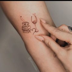 a woman's arm with a tattoo that reads love, books and a glass of wine