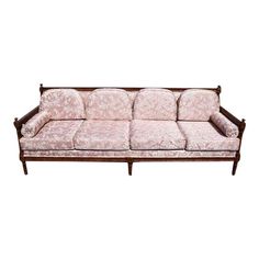 a pink couch sitting on top of a wooden frame