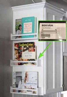 there is a shelf with magazines on it in the kitchen, and an arrow pointing to bekvam