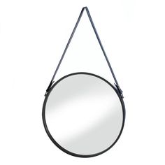 a round mirror hanging on the wall with a black metal frame and leather strap around it