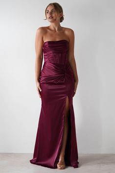 a woman in a long purple dress with a slit down the side and one leg